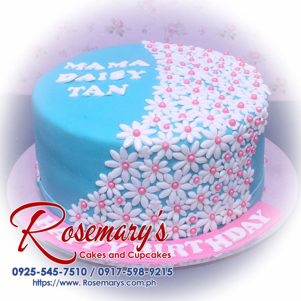 Beautiful one-layer blue cake adorned with delicate white and yellow flowers. Perfect for birthdays or special occasions. Order yours from Rosemary's Cakes: 0925-545-7510.