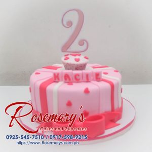 Delicious pink themed cake with delicate heart decorations and a pink ribbon. Perfect for birthdays! Order yours from Rosemary's Cakes, call 0925-545-7510.