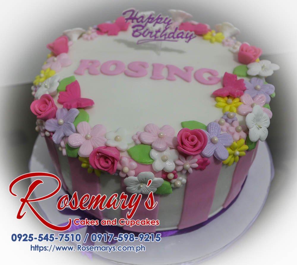 Delicious pink 1-layer birthday cake with delicate fondant flower topper. Order your custom cake from Rosemary's Cakes! Call 0917-598-9215.