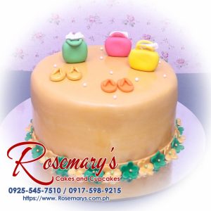 Delicious 1-layer orange cake adorned with fondant slipper and handbag toppers. Perfect for any celebration! Rosemary's Cakes - 0917-598-9215
