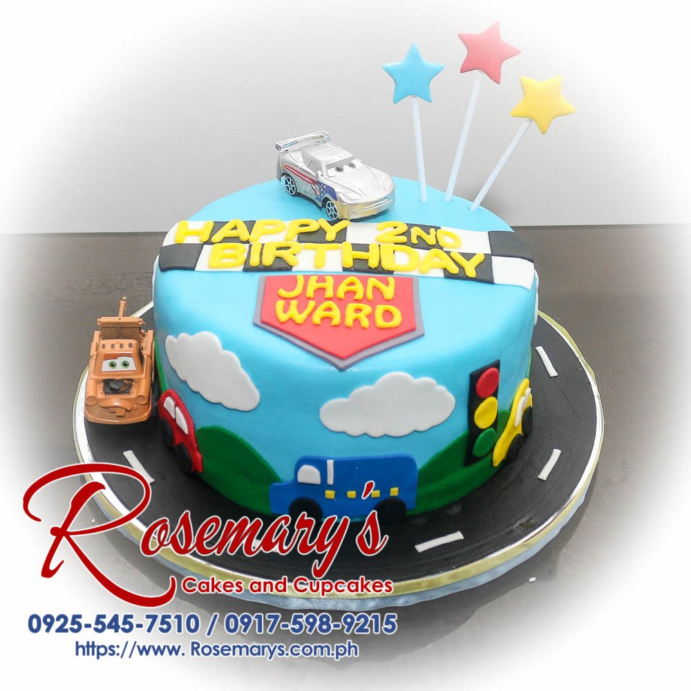 Delicious 1-layer blue car-themed cake decorated with colorful vehicles. Perfect for any celebration! Order yours from Rosemary's Cakes: 0917-598-9215.