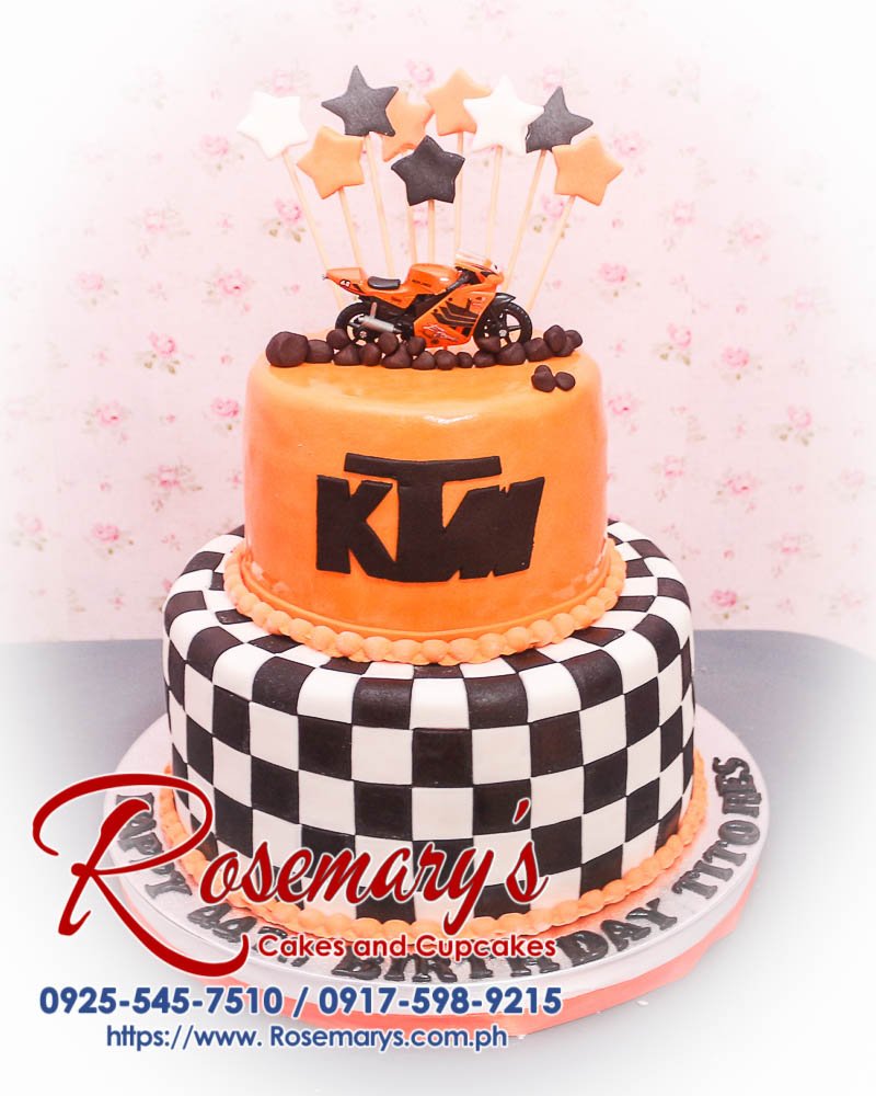 Delicious 2 layer KTM motorcycle themed cake from Rosemary's Cakes, featuring orange and chequered details. Contact: 0917-598-9215.