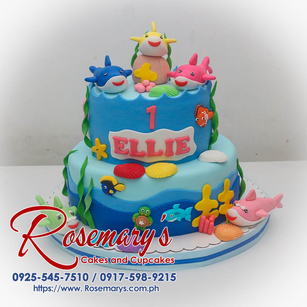 Delicious two-tier blue birthday cake featuring the Baby Shark family. Order custom cakes from Rosemary's Cakes: 0925-545-7510.
