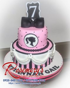 Two-tier pink Barbie cake with delicate frosting details. Perfect for birthdays! Rosemary's Cakes - 0917-598-9215