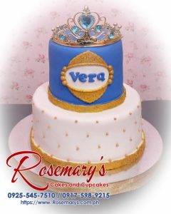 Delicious 2 layer blue and gold princess themed cake with a crown design from Rosemary's Cakes. Contact: 0925-545-7510.