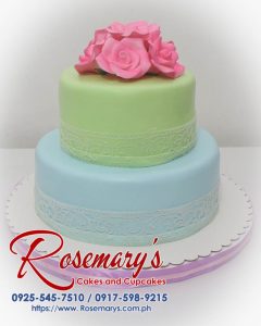 Delicious two-tier blue and green wedding cake with intricate frosting details. Order your custom cake from Rosemary's Cakes: 0925-545-7510.