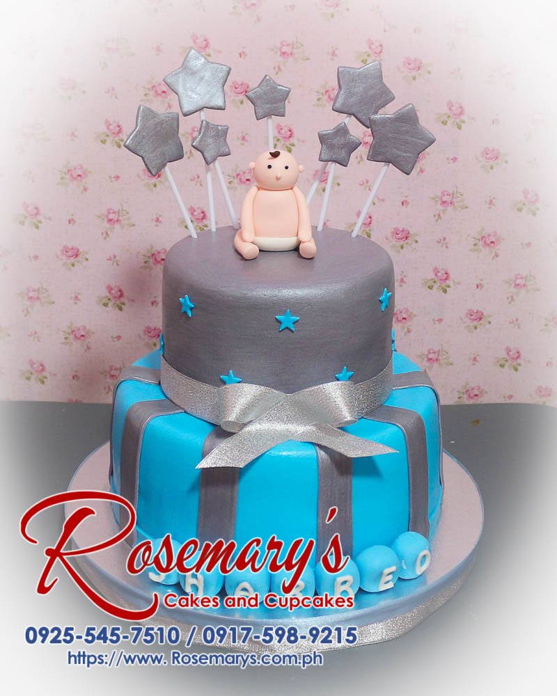 Delicious 2 layer blue and silver themed cake with fondant baby, silver ribbon, and star decorations by Rosemary's Cakes. Contact: 0925-545-7510.