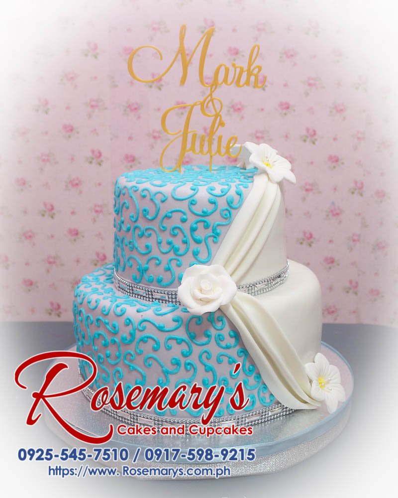 Stunning 2-layer blue and white wedding cake with 3D printed topper. A delicious themed cake from Rosemary's Cakes. Call 0917-598-9215!