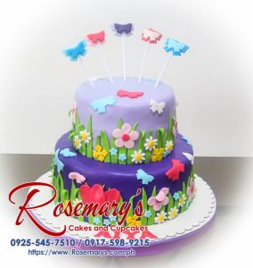 Delicate two-layer pink and purple birthday cake adorned with buttercream butterflies and pink flowers. Order yours from Rosemary's Cakes: 0925-545-7510