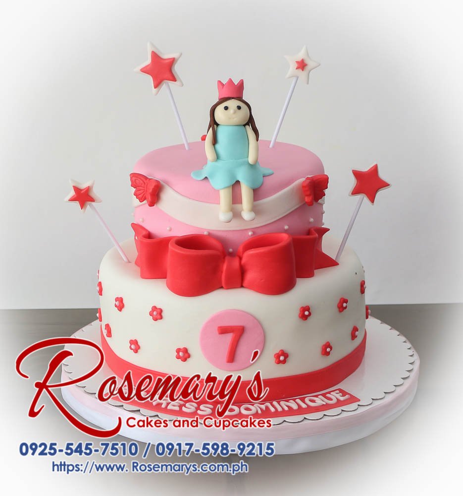 Delicious two-tier pink and white cake adorned with a custom princess fondant topper. Stars accent the design. Order yours from Rosemary's Cakes: 0917-598-9215.