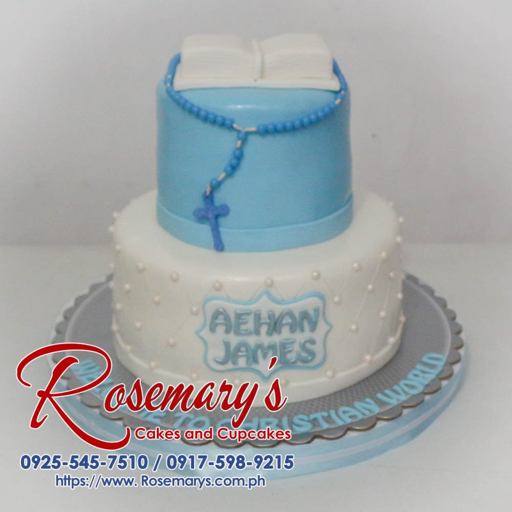 Two-tier vanilla cake with delicate white frosting and sugar flowers, perfect for a christening celebration. Order yours from Rosemary's Cakes! 0925-545-7510