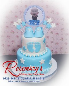 Delicious 2 layer cake with blue baby shoes, footprints, and stars, perfect for a christening. Rosemary's Cakes, 0925-545-7510.