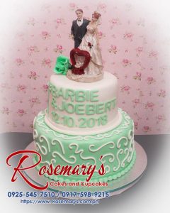 Delicious 2 layer wedding cake featuring green and white themed design, perfect for special occasions. Rosemary's Cakes, 0917-598-9215.