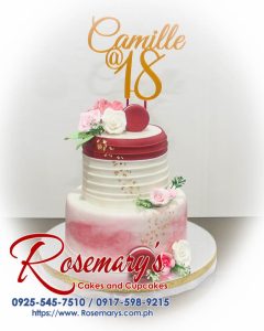 Two-layer maroon cake adorned with edible gold accents and delicate sugar flowers. Features a stunning 3D printed topper. Order your dream cake from Rosemary's Cakes: 0925-545-7510