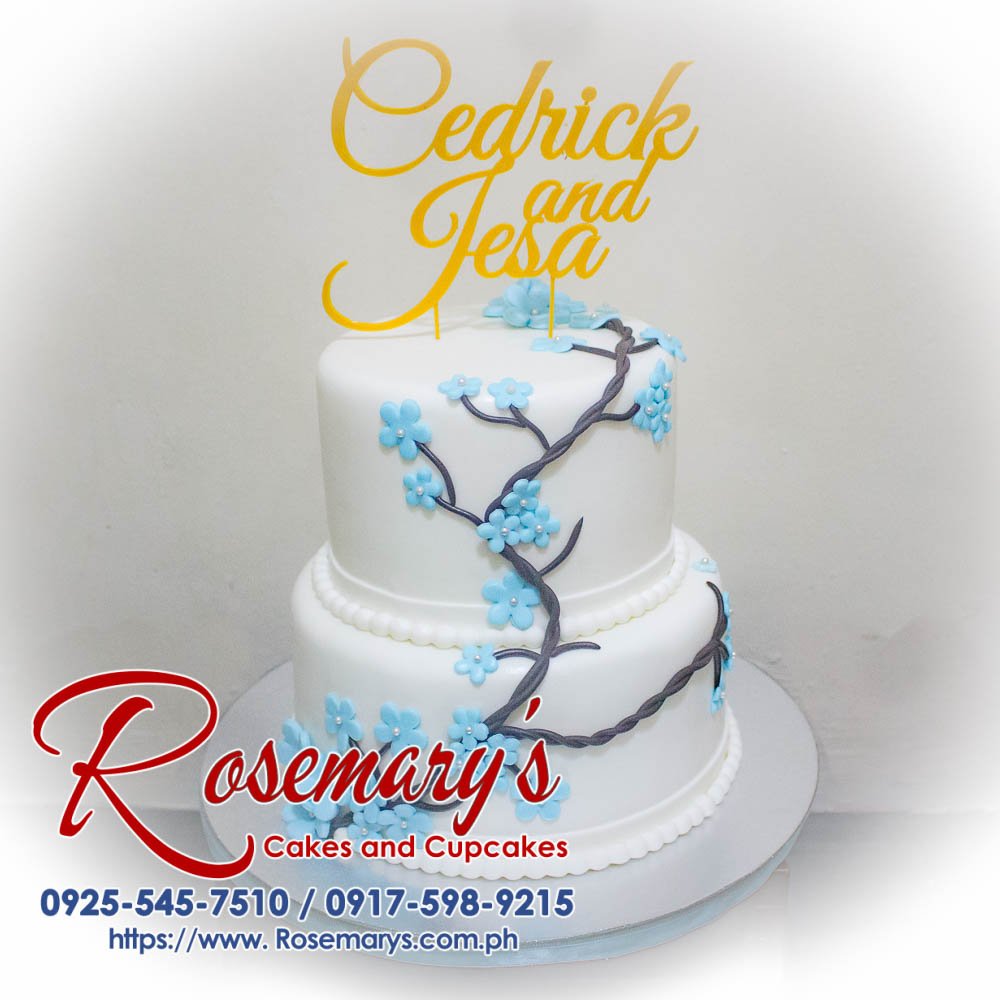 2 Layer Cake for Cedrick and Jesa’s Wedding Delectable two-layer vanilla cake adorned with delicate buttercream roses and a personalized topper. Perfect for weddings & celebrations! Rosemary's Cakes | 0925-545-7510