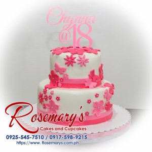 Two-layer pink cake adorned with delicate sugar flowers. Delicious and beautifully themed! Order from Rosemary's Cakes - 0925-545-7510.
