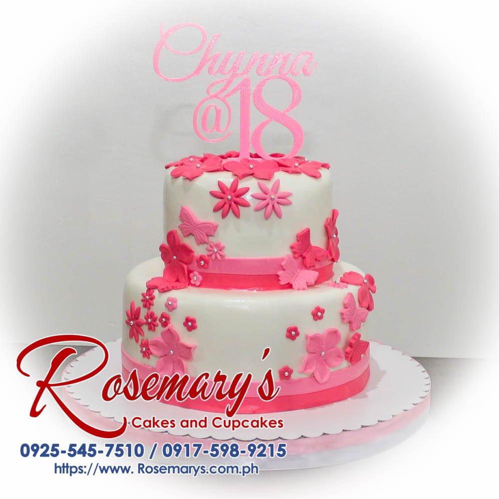 Two-layer pink cake adorned with delicate sugar flowers. Delicious and beautifully themed! Order from Rosemary's Cakes - 0925-545-7510.