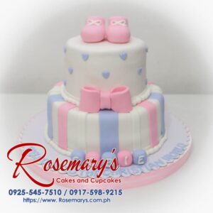 Beautiful two-tier pink and purple cake adorned with delicate fondant baby shoes. Perfect for christenings and baptisms! Rosemary's Cakes | 0917-598-9215