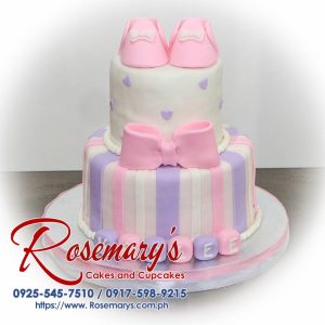 Pink and purple two-layer cake adorned with a ribbon. Deliciously themed confection by Rosemary's Cakes. Call 0917-598-9215.