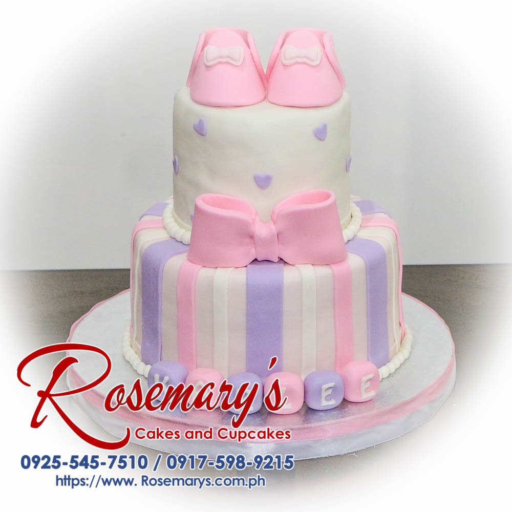 Pink and purple two-layer cake adorned with a ribbon. Deliciously themed confection by Rosemary's Cakes. Call 0917-598-9215.