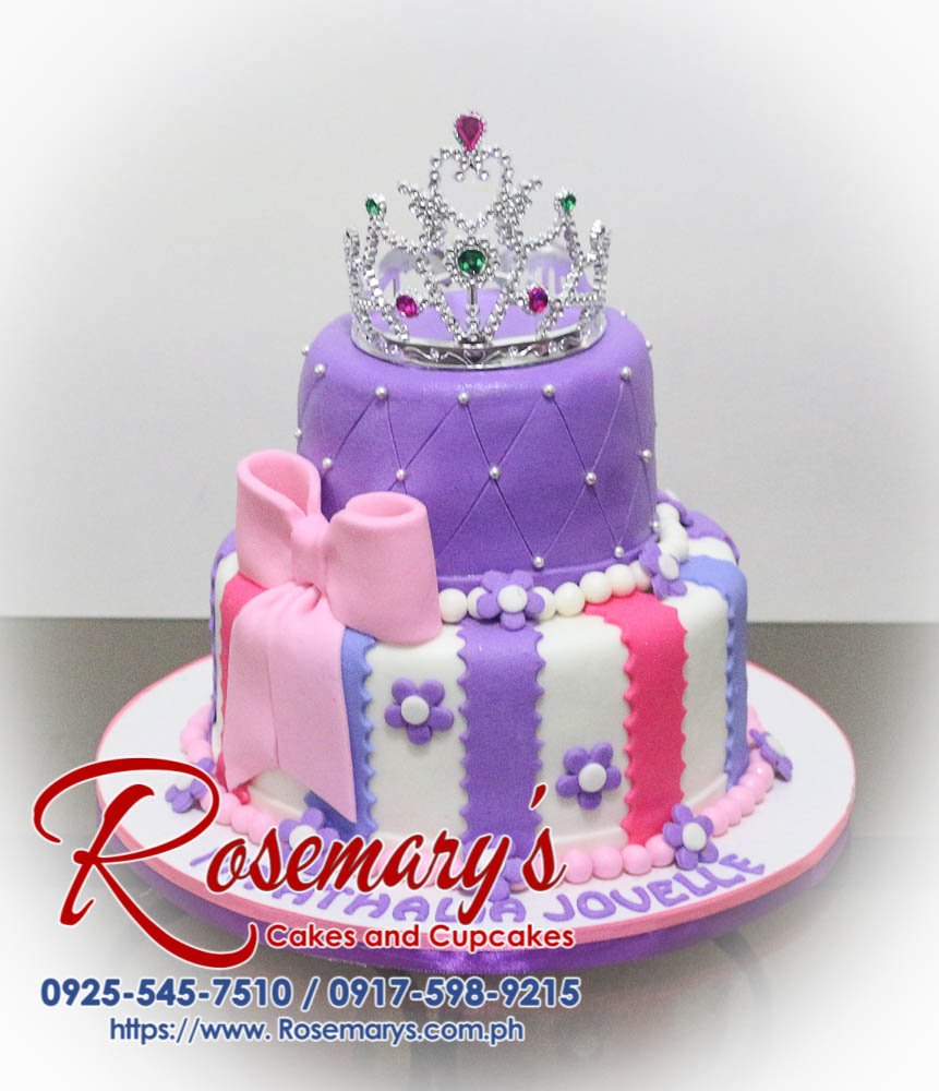 Two-tier pink and purple cake adorned with a gold crown, perfect for any princess celebration. Order yours from Rosemary's Cakes: 0917-598-9215