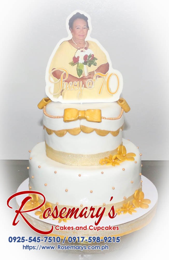 2 Layer Cake for Precy’s 70th Birthday Delicious two-tier cake decorated with elegant gold ribbons. Order your custom cakes from Rosemary's Cakes! Call 0925-545-7510.