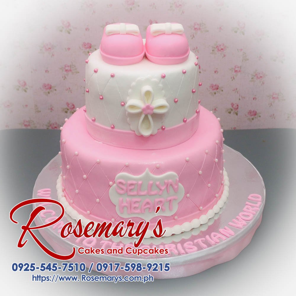 Delicious pink 2 layer cake adorned with baby shoes for a baptism. Perfect for a themed Christening. Rosemary's Cakes, 0917-598-9215.