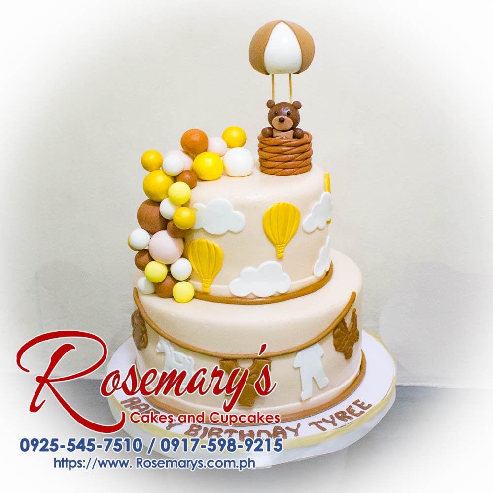 Delicious two-layer cake decorated with a whimsical hot air balloon and teddy bear topper. Rosemary's Cakes - 0925-545-7510