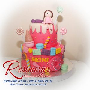 Delicious 2 layer Candy Land themed cake with vibrant pink frosting, colorful candies, and whimsical decorations. Rosemary's Cakes, 0917-598-9215.