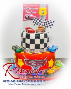 Red two-layer car-themed cake decorated with Lightning McQueen and checkered flags. Get your custom cake from Rosemary's Cakes! Call 0925-545-7510.