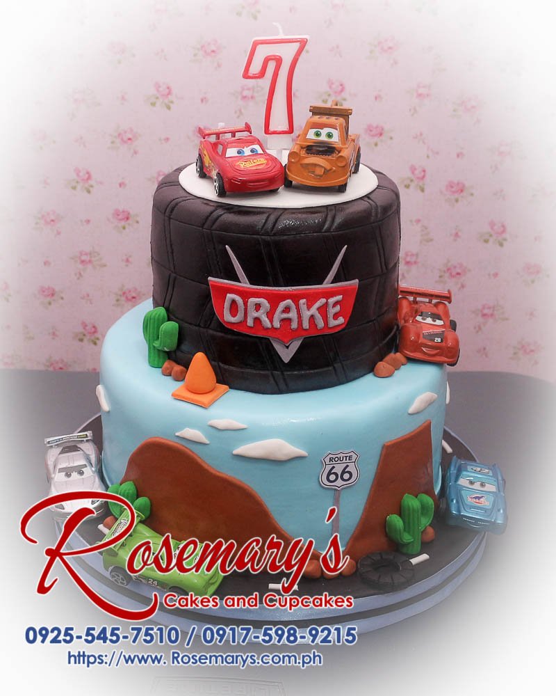 2 layer Cars themed cake in black and blue; delicious and decorative from Rosemary's Cakes, contact 0925-545-7510.