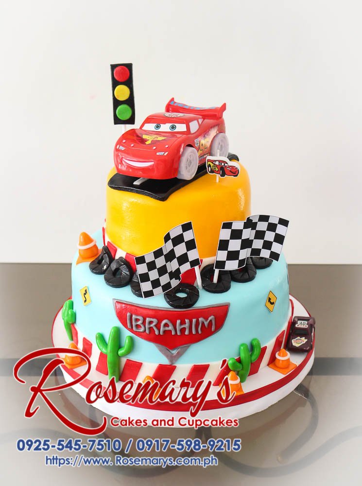 Delicious two-tier cars-themed cake featuring Lightning McQueen. Perfect for any racing fan! Order yours from Rosemary's Cakes: 0917-598-9215