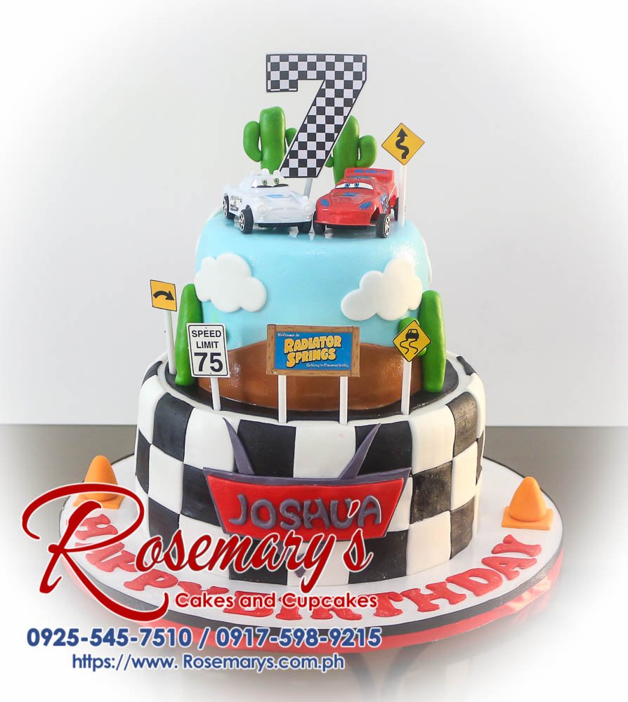 Two-tier chocolate cake decorated with fondant race cars and a Lightning McQueen figurine. Perfect for a birthday celebration! Rosemary's Cakes | 0917-598-9215