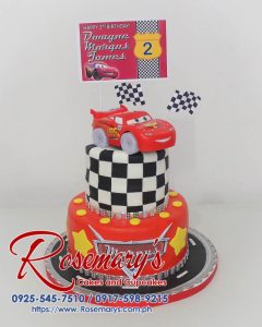 Two-tier chocolate cake decorated with fondant race cars and a checkered flag. Perfect for car enthusiasts! Order from Rosemary's Cakes: 0917-598-9215.