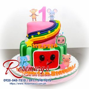 Delicious 2 layer Cocomelon themed cake with vibrant green and pink colors, topped with a rainbow. Order from Rosemary's Cakes: 0925-545-7510.