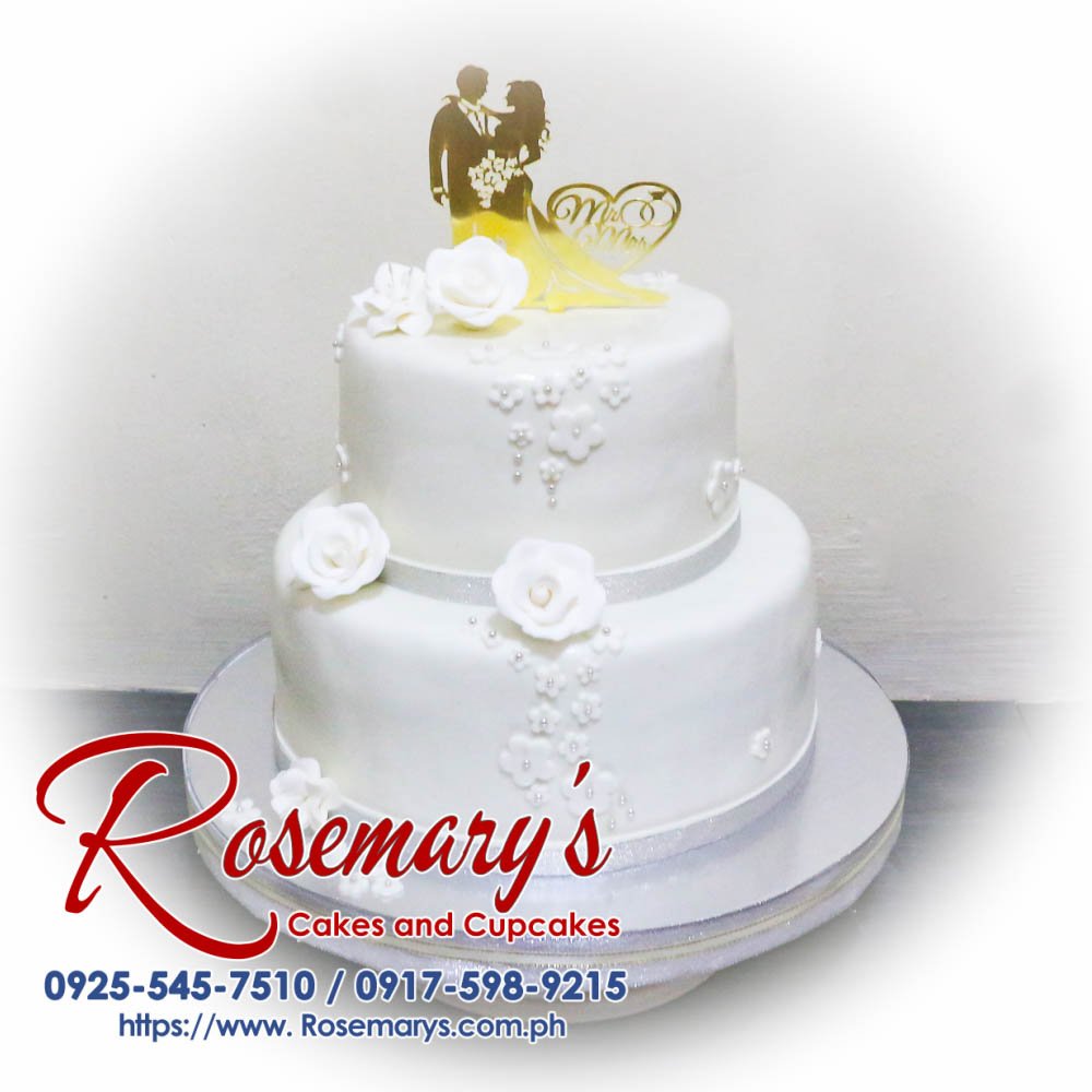2 Layer Elegant White Mr and Mrs Wedding Cake Elegant 2-layer white wedding cake adorned with floral accents, perfect for Mr. and Mrs. celebrations. Rosemary's Cakes, 0925-545-7510.