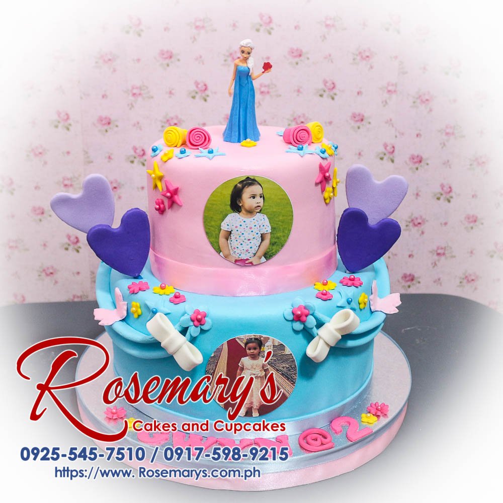 Delicious 2 layer Frozen themed cake from Rosemary's Cakes, featuring blue and pink decor. Contact 0925-545-7510.