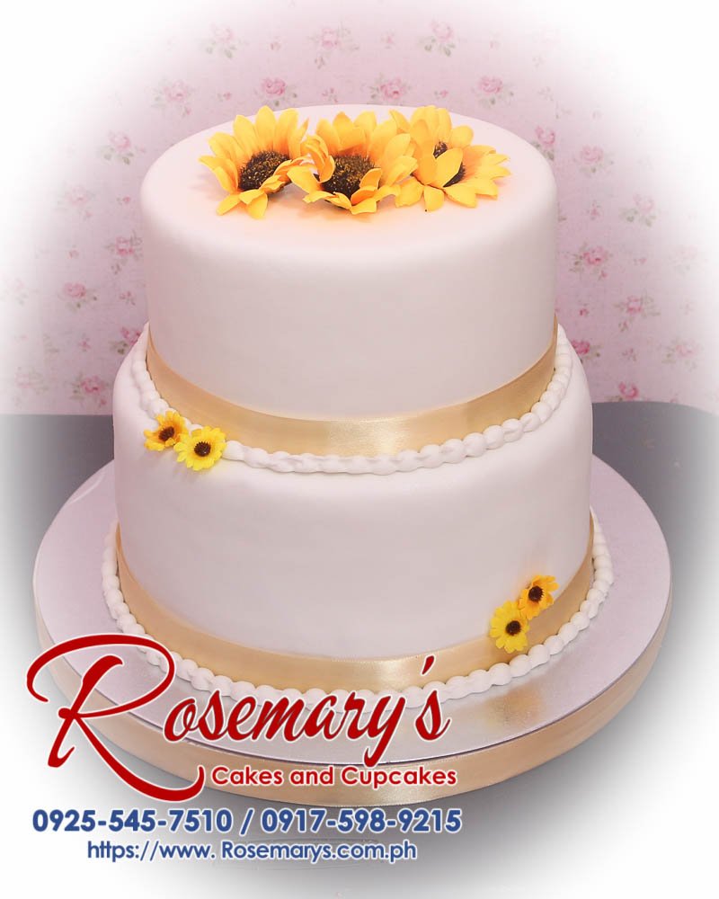 Two-layer gold and white sunflower themed wedding cake from Rosemary's Cakes, featuring elegant floral decor. Contact: 0925-545-7510.