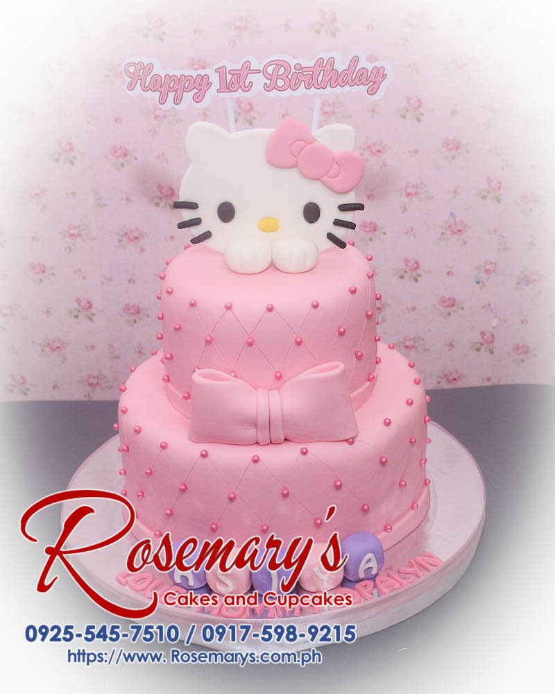 Delicious 2-layer Hello Kitty cake by Rosemary's Cakes, featuring pink frosting and charming decorations. Contact 0917-598-9215.