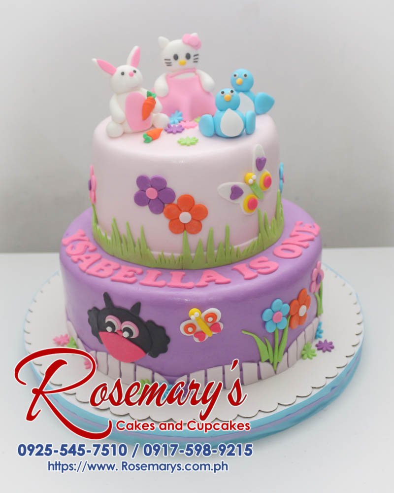Delicious two-tier Hello Kitty cake with pink, purple and white frosting. Order custom cakes from Rosemary's Cakes: 0917-598-9215