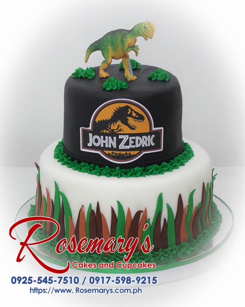 Delicious two-tier black and white Jurassic Park themed cake with green accents. Order your custom cake from Rosemary's Cakes: 0917-598-9215.
