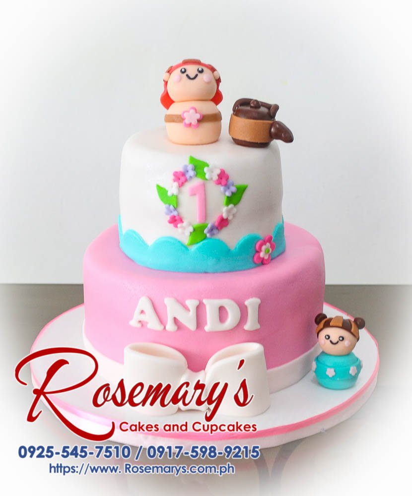 Beautiful two-tier blue and pink cake with a fondant kokeshi doll topper. Perfect for celebrations! Rosemary's Cakes 0917-598-9215.