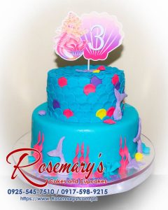 Delicious 2 layer Mermaid Barbie themed cake by Rosemary's Cakes, featuring vibrant colors and intricate designs. Contact: 0925-545-7510.