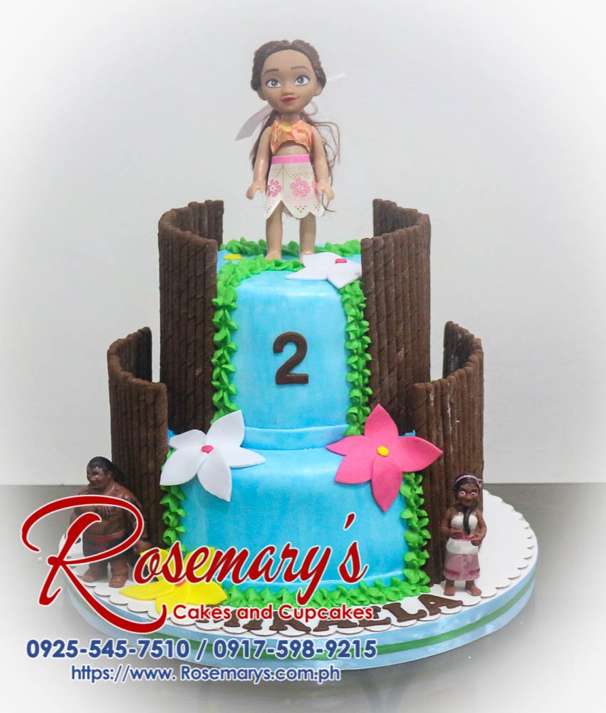 Delicious two-tier blue and brown Moana-themed cake with green accents. Order your custom cake from Rosemary's Cakes: 0917-598-9215.