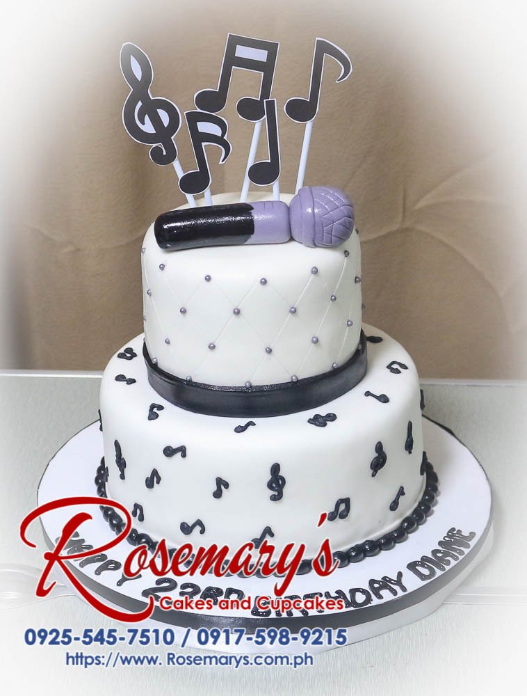 Delicious two-tier black and white cake decorated with musical notes and a custom fondant microphone topper. Order your own unique cake from Rosemary's Cakes! 0925-545-7510.
