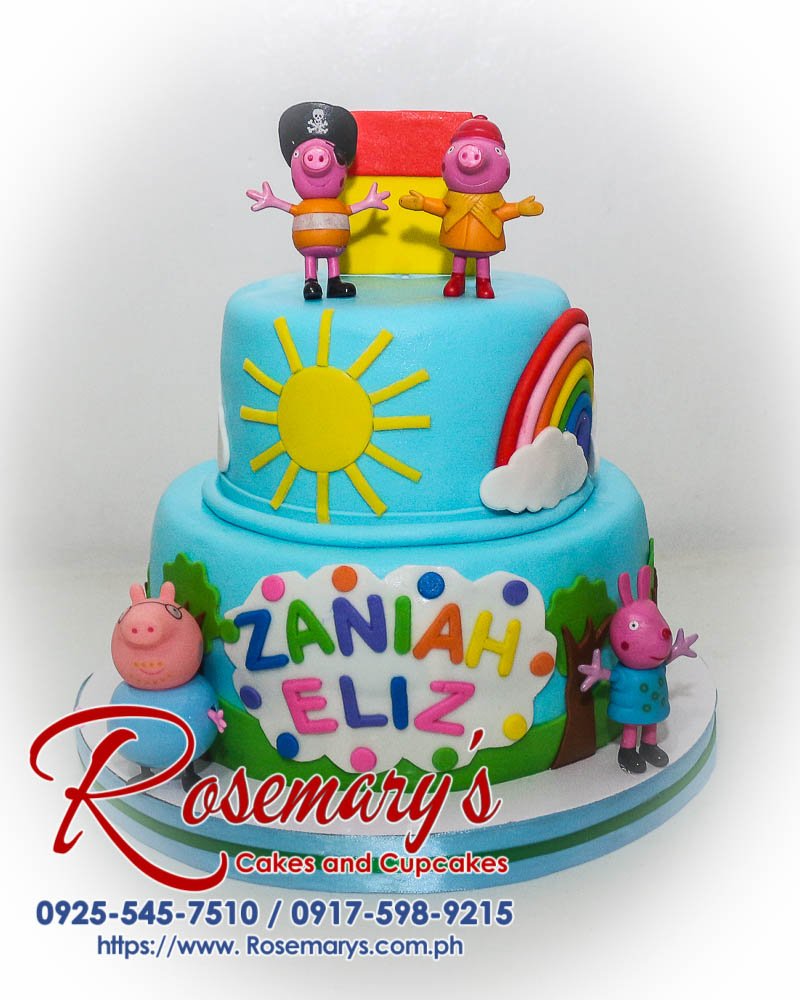 Delicious two-layer Peppa Pig themed cake with vibrant blue frosting and a playful rainbow design. Order yours from Rosemary's Cakes! 0925-545-7510