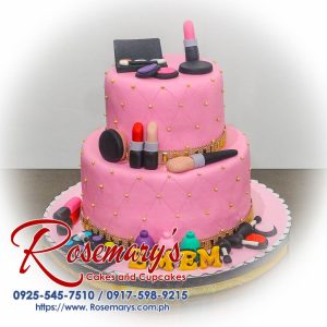 Two-layer pink cake decorated with edible makeup brushes and lipsticks. Perfect for birthdays! Order yours from Rosemary's Cakes, 0925-545-7510.