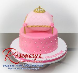 Two-layer pink pillow cake adorned with a gold crown. Perfect for birthdays or special occasions. Rosemary's Cakes | 0917-598-9215