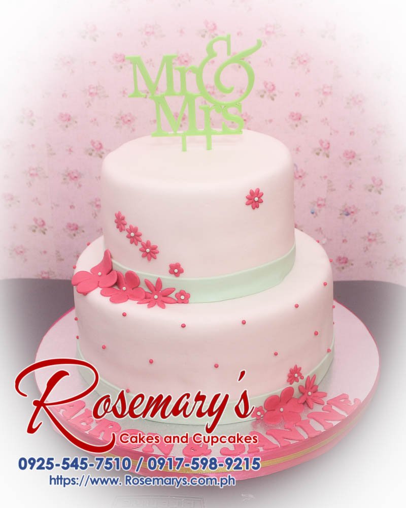 Delicious 2-layer pink and green wedding cake with a 3D printed Mr and Mrs topper, crafted by Rosemary's Cakes. Call 0917-598-9215.