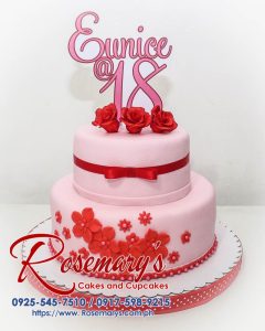 Two-tier pink and red birthday cake adorned with elegant decorations. Order your custom cake from Rosemary's Cakes: 0917-598-9215.